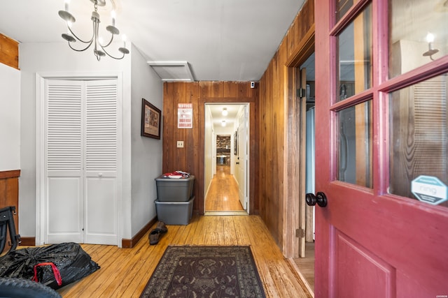 interior space featuring light wood-style floors and wooden walls