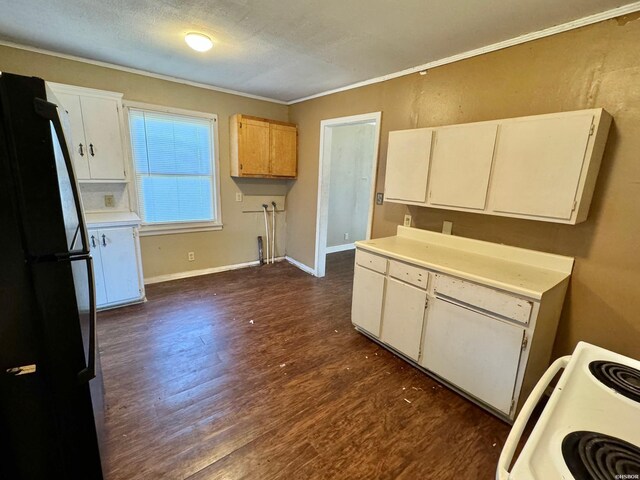 kitchen featuring dark wood-style floors, electric stove, light countertops, freestanding refrigerator, and white cabinetry