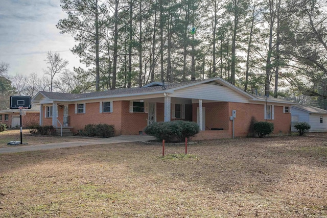 ranch-style home with brick siding and a front lawn