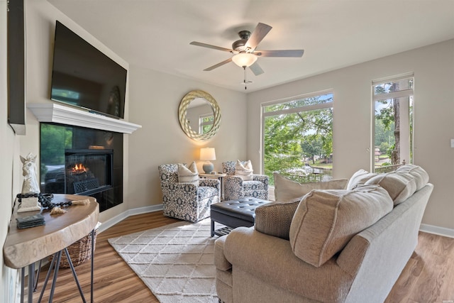 180 Port Au Prince, Hot Springs, AR 71913 - living area featuring ceiling fan, wood finished floors, a tiled fireplace, and baseboards