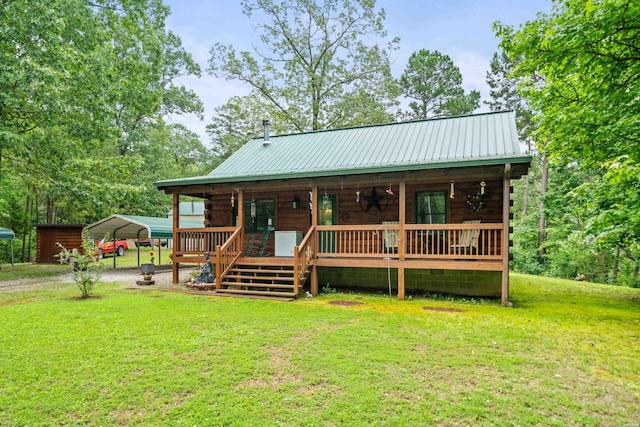273 Alydar Trl, Hot Springs, AR 71901 - log cabin featuring a front yard, a detached carport, covered porch, and a metal roof
