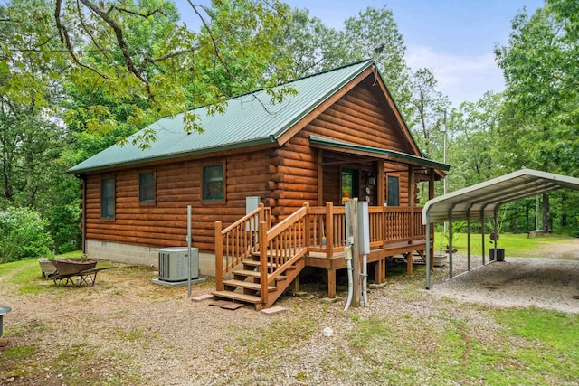 273 Alydar Trl, Hot Springs, AR 71901 - view of front of house featuring a carport, a metal roof, and log exterior