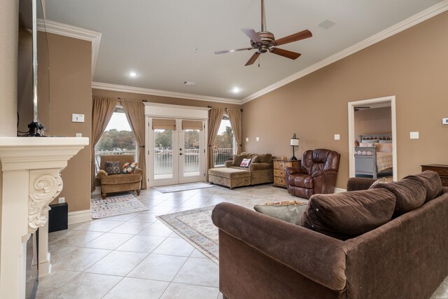 living room with light tile patterned floors, lofted ceiling, ceiling fan, ornamental molding, and french doors