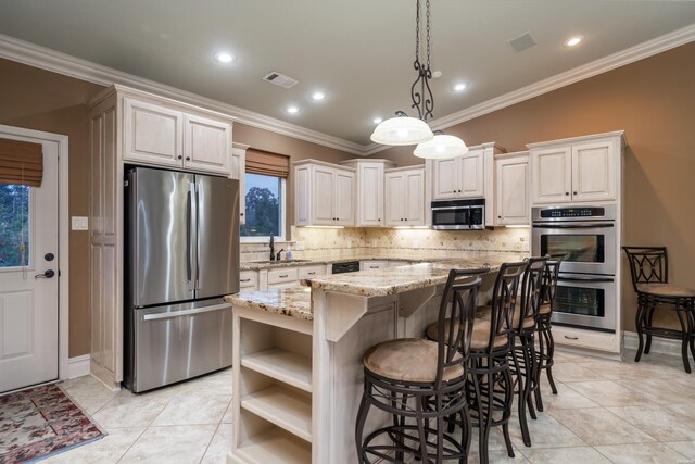 kitchen with visible vents, a kitchen island, decorative light fixtures, stainless steel appliances, and open shelves