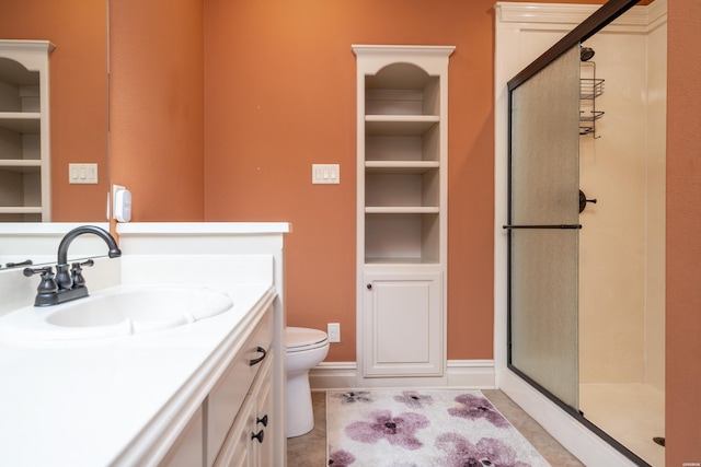 bathroom with toilet, a stall shower, tile patterned flooring, and vanity