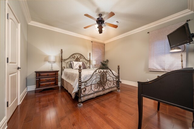 bedroom with baseboards, visible vents, dark wood-style flooring, and ornamental molding