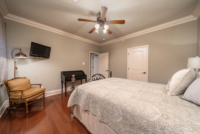 bedroom with baseboards, dark wood-style flooring, and crown molding