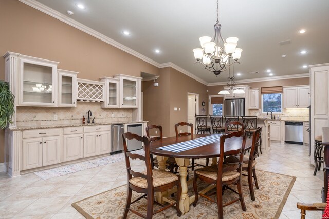 dining room featuring ornamental molding, recessed lighting, light tile patterned flooring, and an inviting chandelier