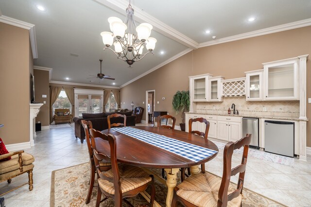 dining area featuring indoor wet bar, crown molding, and ceiling fan with notable chandelier