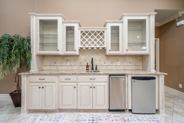 kitchen featuring glass insert cabinets, white cabinets, a sink, and fridge