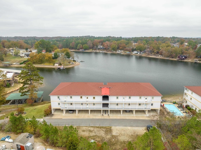 drone / aerial view with a water view and a wooded view