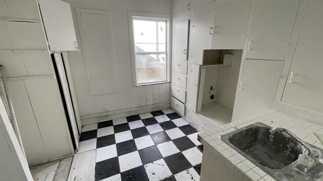 bathroom with a sink and tile patterned floors