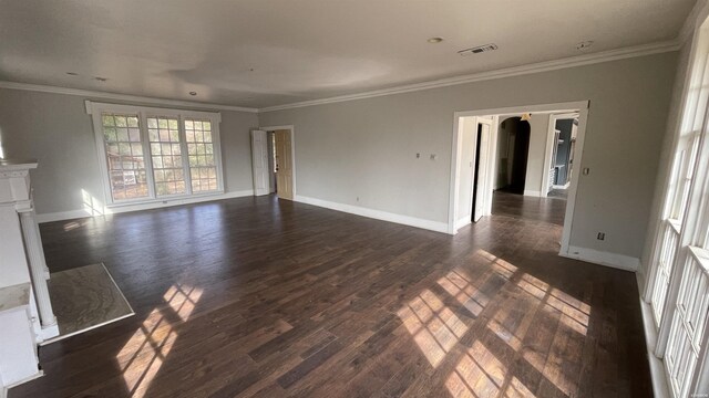 unfurnished living room with dark wood-style flooring, visible vents, and crown molding