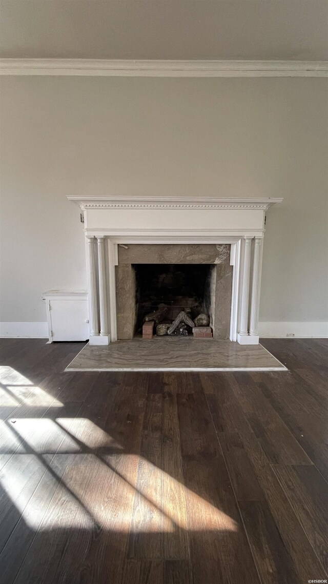 details with crown molding, a fireplace, baseboards, and wood finished floors