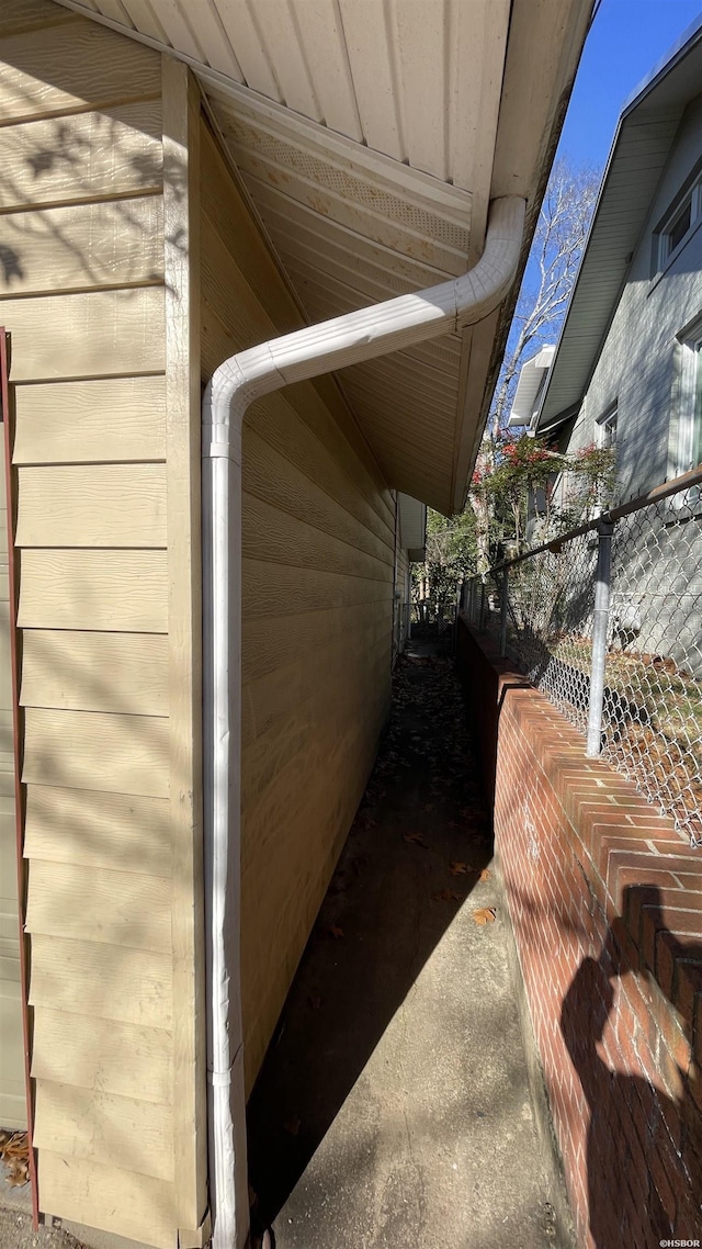 view of side of home featuring fence