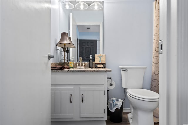 full bath featuring visible vents, vanity, and toilet