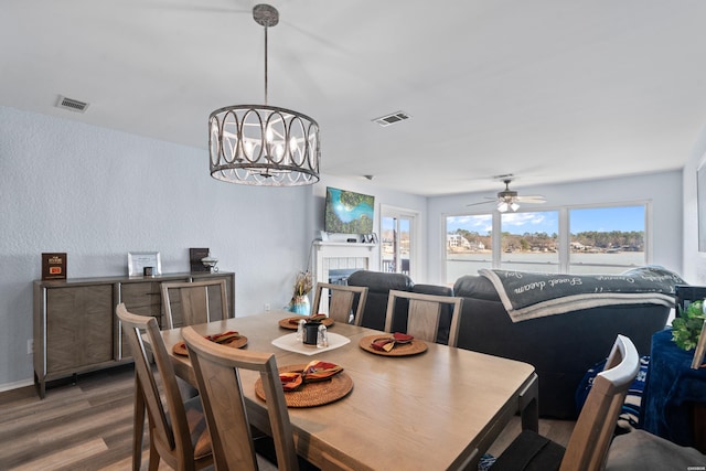 dining room featuring wood finished floors, visible vents, and a healthy amount of sunlight