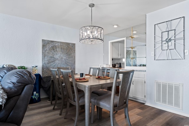 dining area with dark wood-style floors, visible vents, and an inviting chandelier