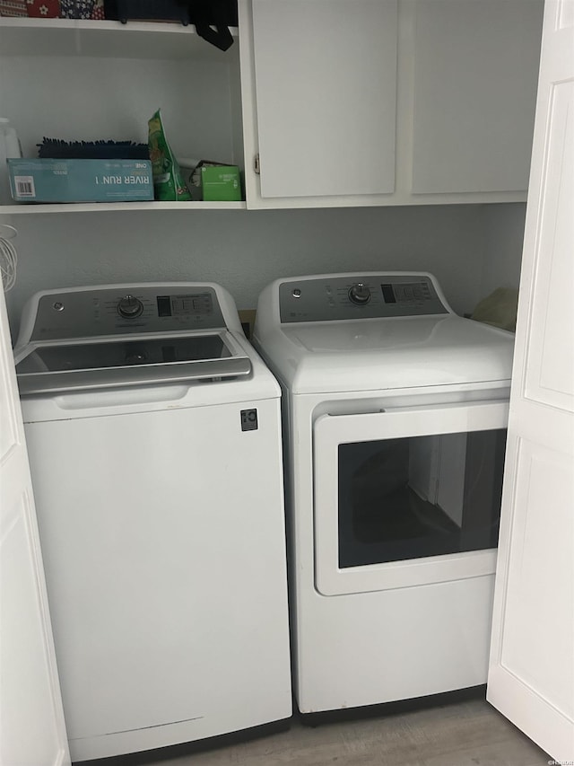 310 Kleinshore Rd Unit C6, Hot Springs, AR 71913 - washroom featuring washing machine and clothes dryer, cabinet space, and wood finished floors