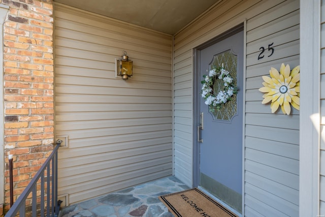 entrance to property featuring brick siding