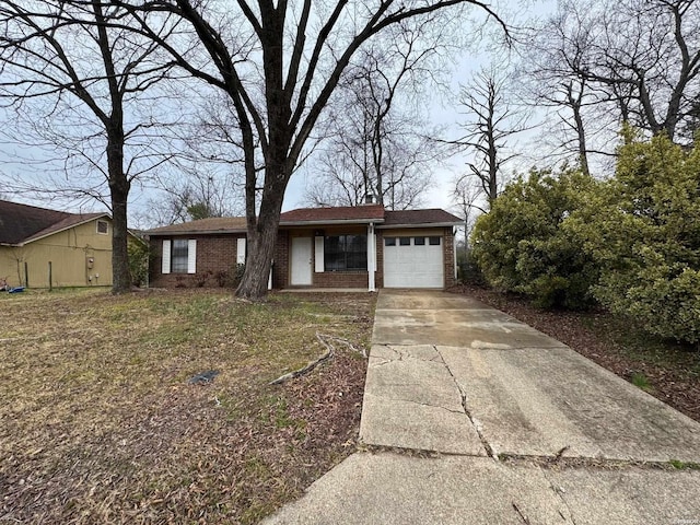 view of front of property featuring an attached garage, brick siding, driveway, a chimney, and a front yard