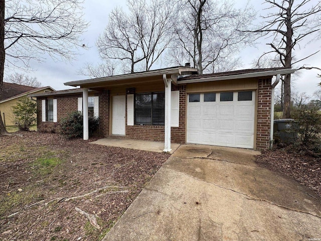 single story home with brick siding, driveway, and an attached garage