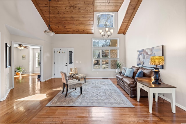 living area featuring wooden ceiling, hardwood / wood-style flooring, baseboards, and high vaulted ceiling