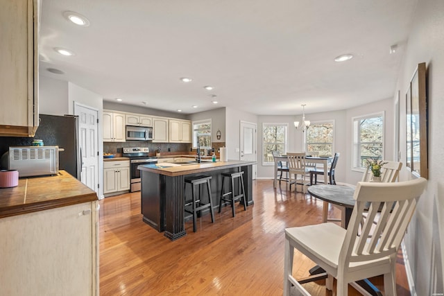 kitchen with a wealth of natural light, recessed lighting, light wood-style flooring, and appliances with stainless steel finishes