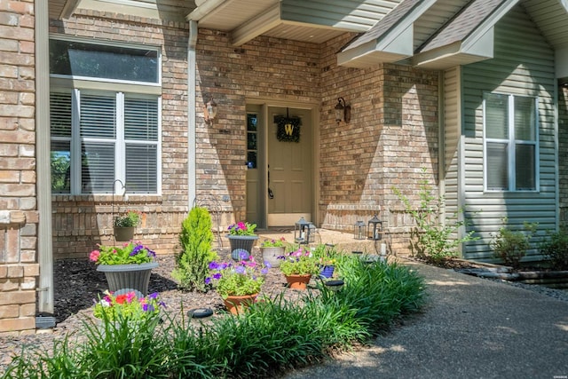 view of exterior entry with brick siding