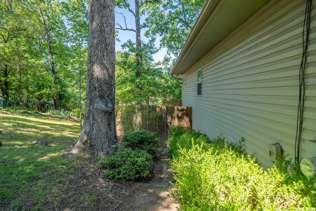 view of side of home featuring fence