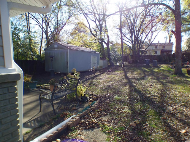 view of yard with a shed, an outdoor structure, and a fenced backyard