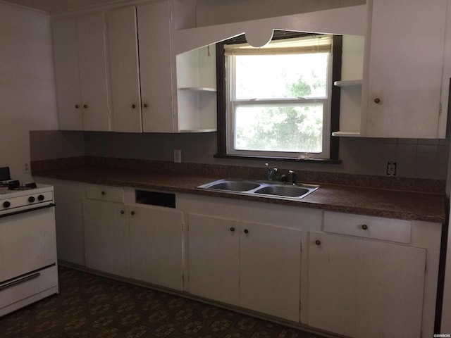 kitchen featuring open shelves, dark countertops, white cabinetry, white range with gas cooktop, and a sink