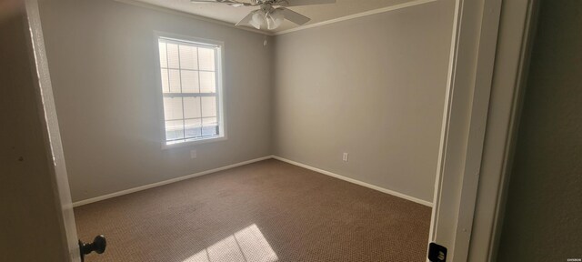 carpeted empty room featuring ceiling fan, ornamental molding, and baseboards