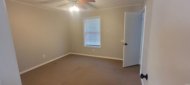 carpeted empty room featuring baseboards, a ceiling fan, and crown molding