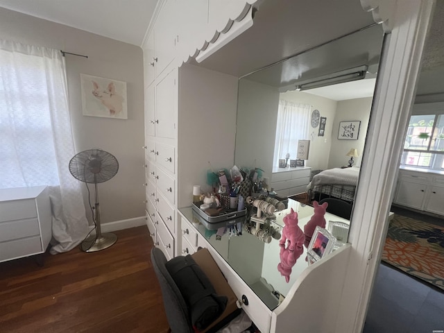 bedroom featuring dark wood finished floors and baseboards