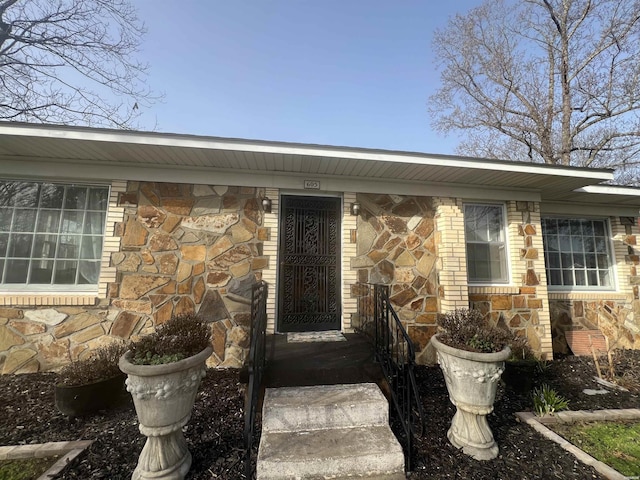 property entrance with stone siding