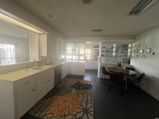 kitchen featuring a sink, visible vents, white cabinets, light countertops, and stainless steel dishwasher