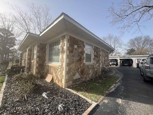 view of side of property with crawl space and stone siding