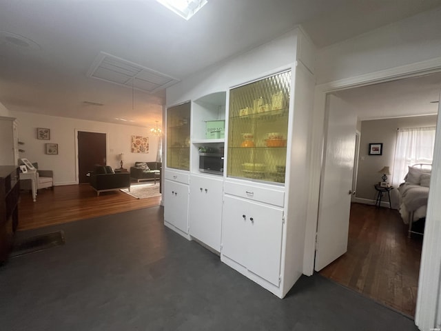 interior space featuring attic access and dark wood finished floors