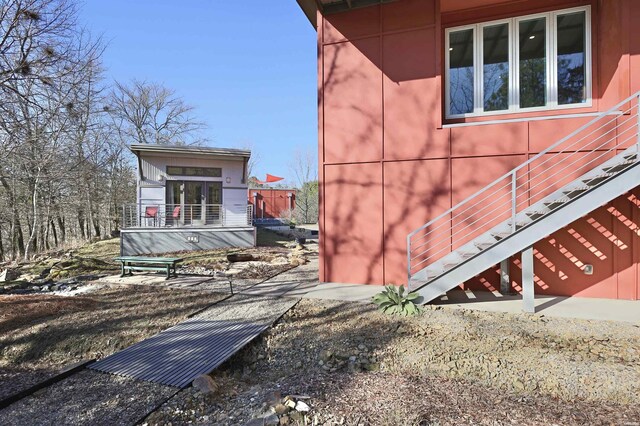 view of side of home with a deck and stairway