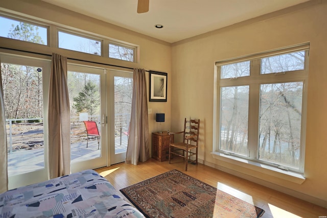 bedroom with light wood-type flooring, access to outside, and recessed lighting