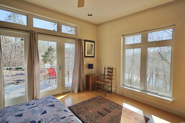 bedroom with light wood-type flooring, access to outside, and recessed lighting