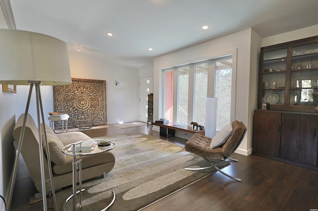 living room with baseboards, dark wood-type flooring, and recessed lighting