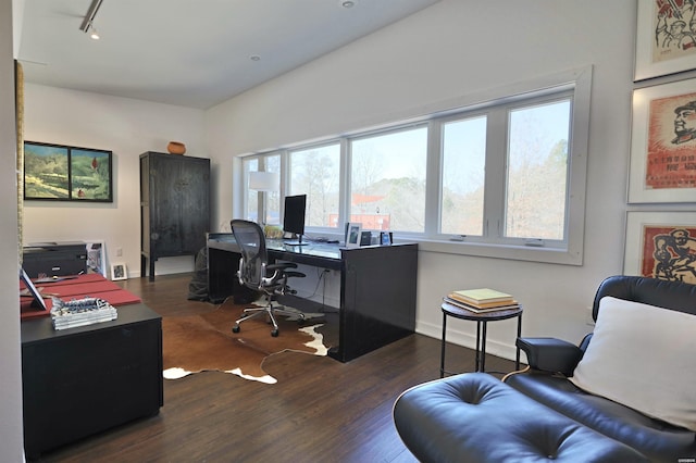 office area featuring dark wood-style floors, track lighting, and baseboards