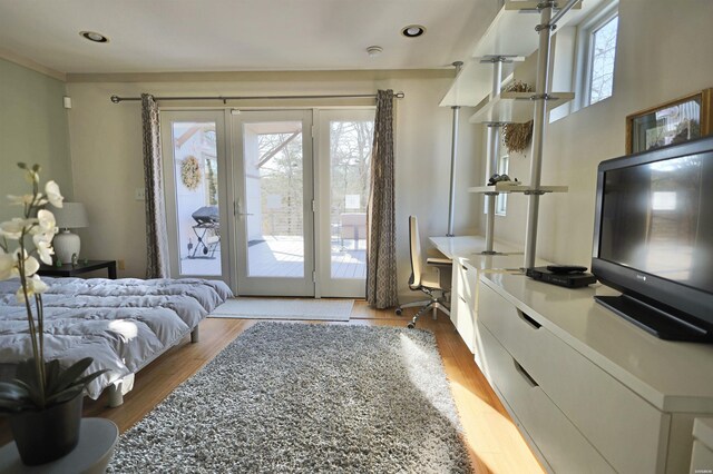 bedroom featuring access to outside, wood finished floors, and recessed lighting