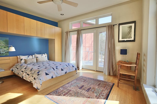 bedroom featuring light wood-type flooring, access to exterior, and a ceiling fan