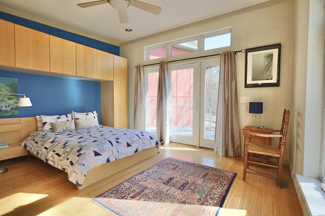 bedroom featuring light wood-type flooring, access to exterior, and a ceiling fan