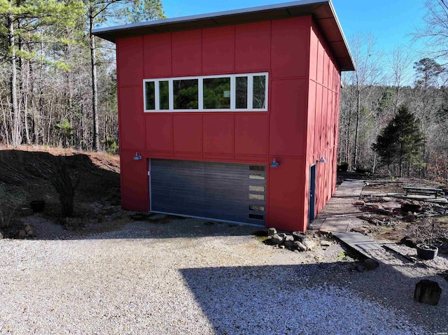 view of outbuilding featuring a garage and driveway