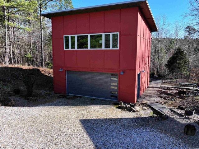 view of outbuilding featuring a garage and driveway