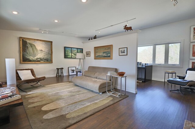 living room featuring baseboards, dark wood-type flooring, and recessed lighting